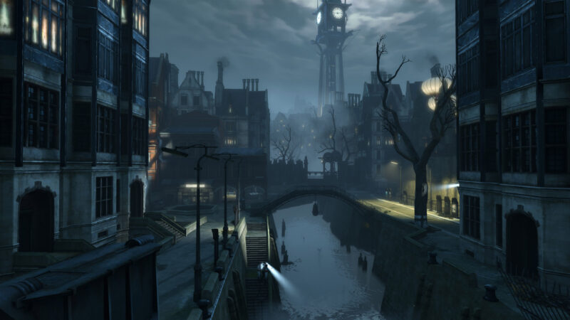 A foggy, dimly lit cityscape featuring ancient buildings, a clock tower in the background, bare trees, and a river reflecting light from a distant source.