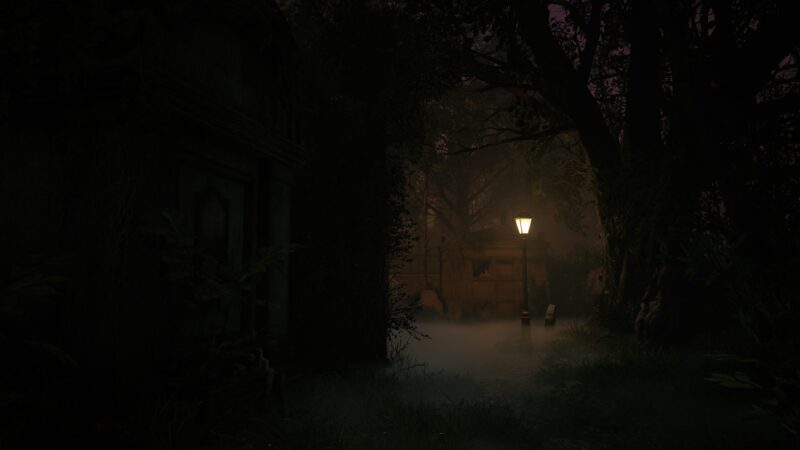 A dimly lit path leads through a foggy, overgrown area with a solitary streetlamp illuminating two empty chairs amidst dark trees and shadows.