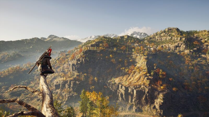 A character perches on a log overlooking a vast landscape of mountains and autumn foliage, bathed in warm sunlight with distant settlements visible on the hillsides.