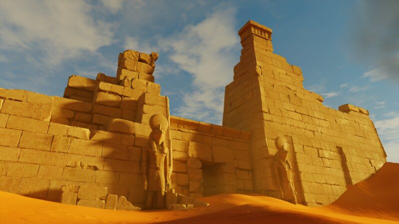 Ancient stone structures with towering statues stand against a backdrop of a blue sky and wispy clouds, surrounded by vast, undulating sand dunes.
