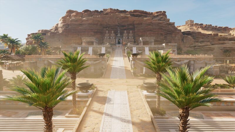 A grand temple complex rises amidst rocky cliffs, with palm trees lining the pathway leading to intricately carved stone structures and a bright blue sky overhead.