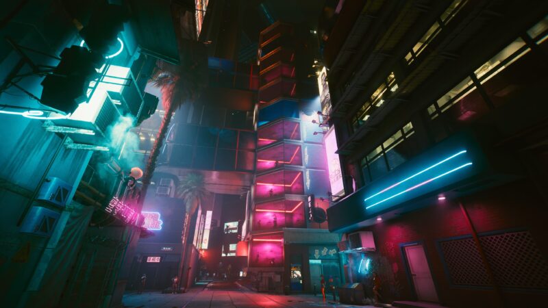 A vibrant, neon-lit urban alley features towering buildings with colourful lights, palm trees, and a mix of shadows, creating a futuristic, cyberpunk atmosphere.