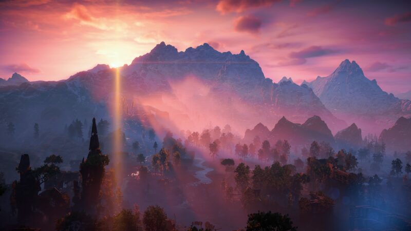 A breathtaking landscape features majestic mountains bathed in a vibrant sunset, with rays of light piercing through mist and lush greenery in the foreground.