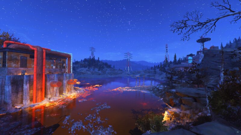 A tranquil, starry night scene with a glowing orange-red industrial structure by a dark, reflective lake, surrounded by trees and distant power lines under a clear sky.
