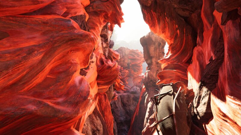 A vibrant canyon with swirling red rock formations, illuminated by bright light, creates a dramatic, otherworldly environment, featuring a rugged path and a darkened crevice.