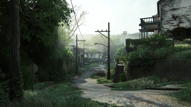 A overgrown, deserted street reveals dilapidated buildings, broken power lines, and scattered debris under soft, diffused sunlight filtering through greenery.