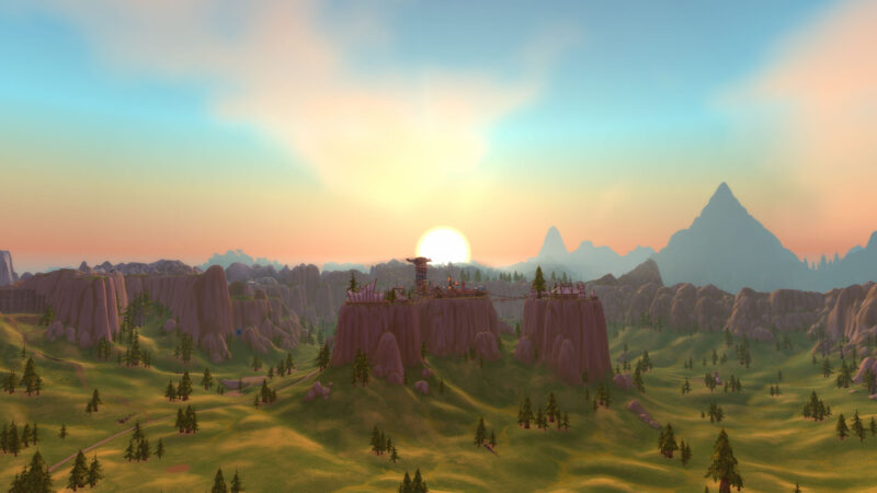 A scenic landscape featuring rolling hills and rocky formations, with a vibrant sunset illuminating the sky, casting warm hues over distant mountains and sparse pine trees.