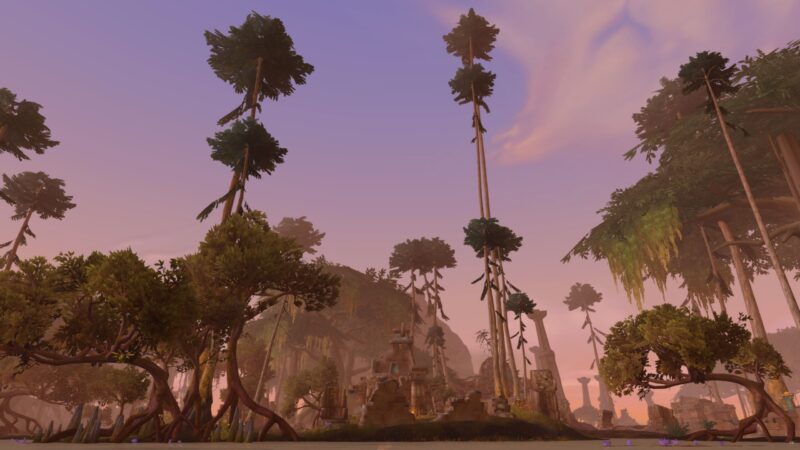 Towering trees with slender trunks rise above a lush, green landscape under a pastel sky, featuring ancient ruins partially obscured by dense vegetation and reflected in calm water.