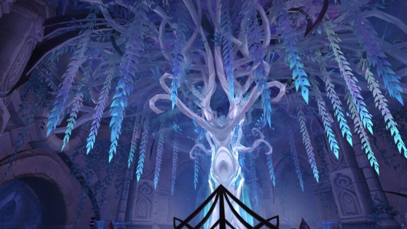 A towering, ethereal tree with translucent branches and glowing blue leaves dominates a dimly lit, ancient chamber filled with intricate stone carvings and lush, dark foliage.