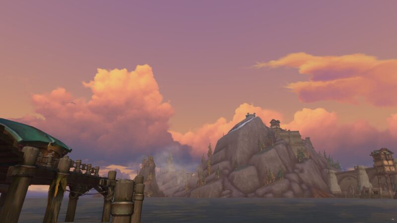 A serene waterfront scene features wooden docks with a distant rocky mountain and a castle, under a sky filled with fluffy pink and orange clouds, reflecting twilight hues.