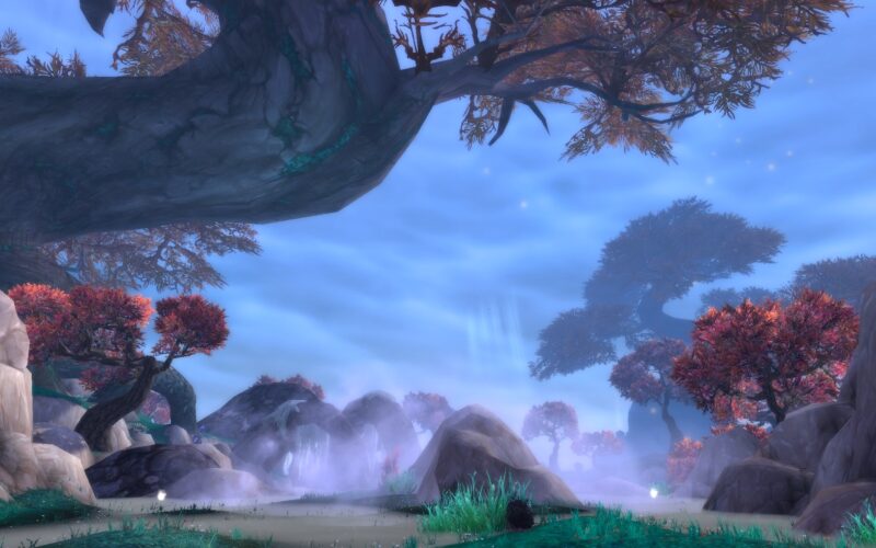 A serene landscape featuring towering trees with autumn foliage, mist hovering over rocky terrain, and soft light filtering through a cloudy sky.