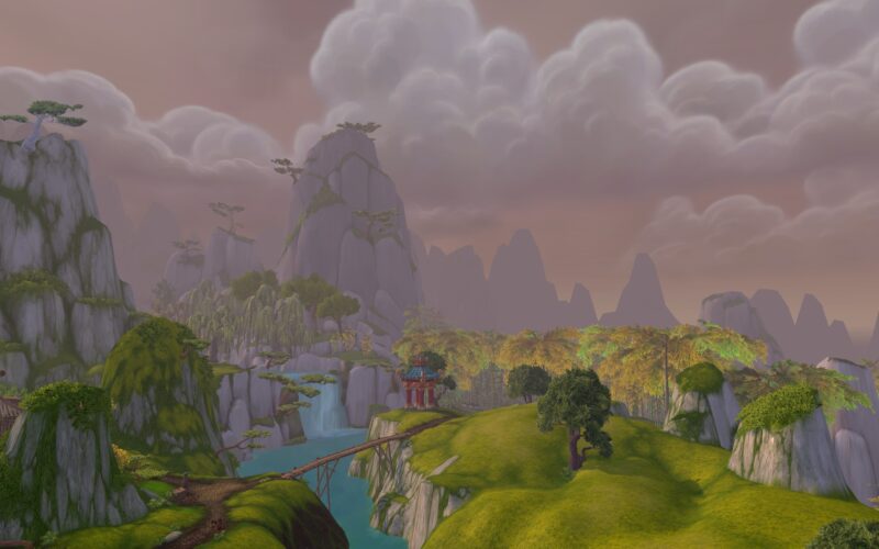 A serene landscape featuring misty mountains, lush greenery, and a tranquil body of water, with a small bridge connecting to a distant structure under a cloudy sky.